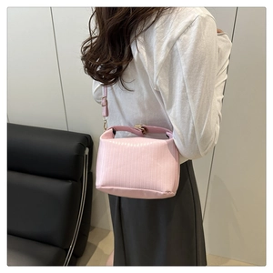 Pink vertical stripe textured PU leather shoulder bag featuring a snap closure buckle