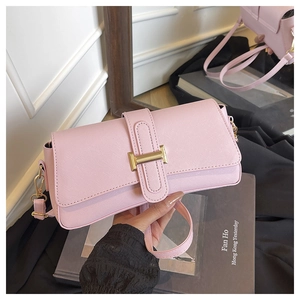 Detail of pink Saffiano leather texture and gold rectangular clasp on women's handbag