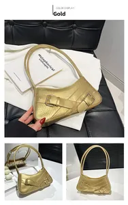 Detailed view of a gold croc-embossed underarm bag with stylish double metal buckles