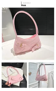 Detailed macro of pink crocodile pattern patent leather handbag with gold metal buckles