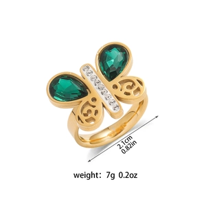 Vue détaillée d'une bague papillon dorée avec pierres vertes et dimensions