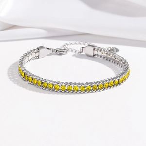 Detail of adjustable stainless steel bracelet with yellow zircon stones and double silver chain