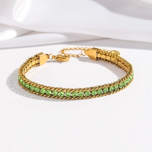 Detail of gold-plated stainless steel bracelet with green zircon stones and lobster clasp