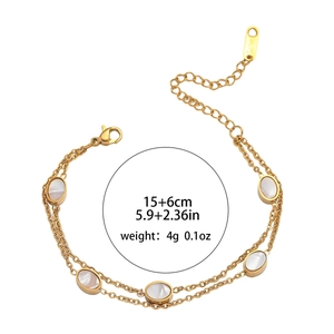 Gold double-layer stainless steel bracelet with oval white shell charms and lobster clasp