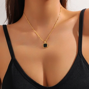 Minimalist gold ball chain necklace with a black square pendant for elegant women