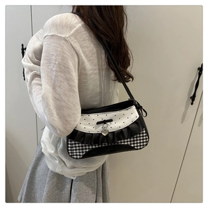 Detail of Y2K style contrast shoulder bag with heart pendant and ruffled lace edges