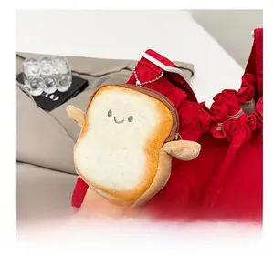 Detail of plush toast bread bag charm with happy face attached to a red tote bag