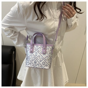 Detail of lavender mini crossbody bag with floral embroidery and detachable strap