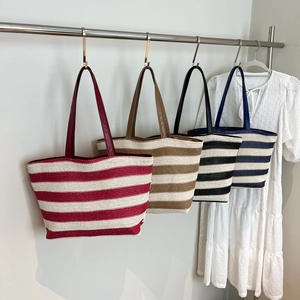 Striped woven tote bags in four colors hanging for commute and beach vacations