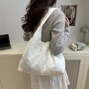 White embroidered tote bag for women featuring floral lace texture and minimalist design