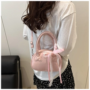 Pink pillow bag with delicate lace bow handle decoration and adjustable shoulder strap