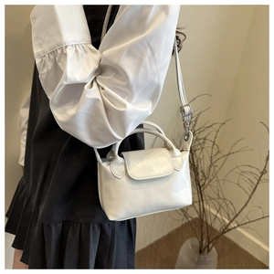 Vue détaillée du sac à main blanc en cuir avec poignée et bandoulière réglable amovible