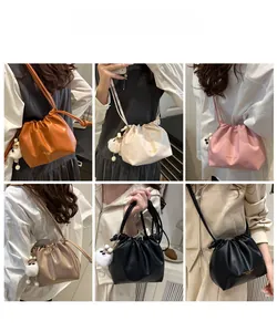 Collage showing drawstring bucket bags in multiple colors with plush pom pom charms