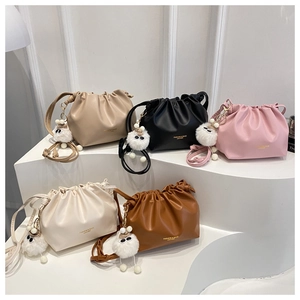 Detailed view of gathered cloud bags in five colors with cute plush monster charms