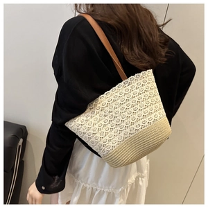 Close-up of white lace and beige straw woven patchwork tote with brown leather straps