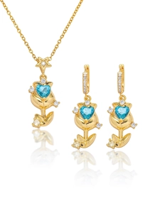 Detail of tulip flower jewelry set with blue heart zircon stones in gold plating
