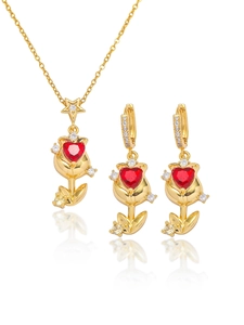Close-up of golden tulip jewelry set with red heart zircon and shimmering crystals