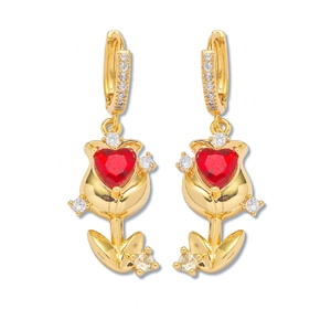 Golden tulip earrings with red heart stones and sparkling zircon accents on white background