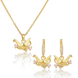 Detailed view of golden paper crane jewelry set with pink and clear zircon crystals