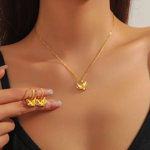 Golden origami paper crane jewelry set including necklace and hoop earrings for women