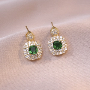 Elegant gold drop earrings with emerald green zircon stones and white halo accents