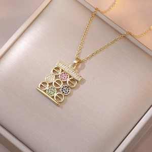 Macro shot of gold abacus pendant with colorful zircon stones on a premium jewelry box