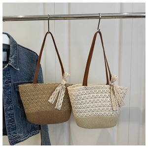 Detail of hollow-out woven tote bag with lace trim and leather shoulder strap