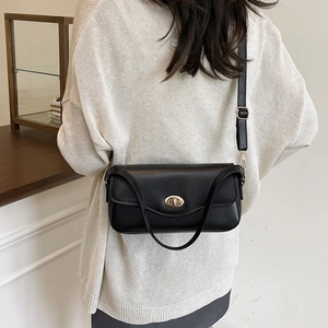 Minimalist black leather crossbody bag with golden turn-lock for casual daily use