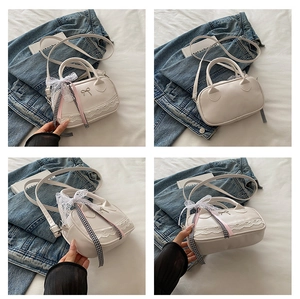 Detailed views of a white crossbody bowling bag with lace trim and ribbon bow accents