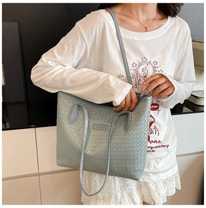 Detail of light blue woven tote bag with checkerboard pattern and slim shoulder straps