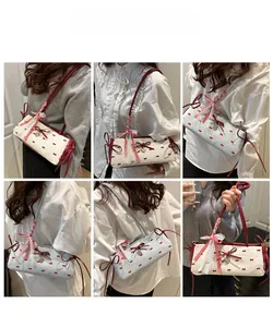 Detailed views of sweet bow shoulder bags in cream and light blue with heart charms