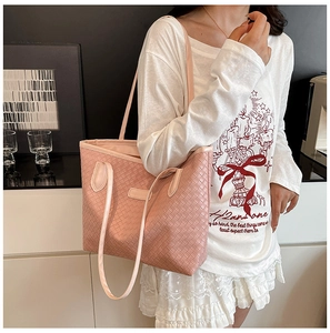 Detail of pink woven checkerboard tote bag with dual handles and spacious interior