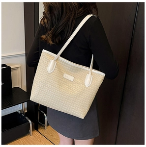 Detail of woven texture tote bag featuring a Fashion & Bags metallic plaque on beige material