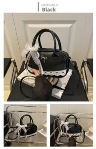 Detail of black Lolita style handbag with white lace trim and heart-shaped cutouts