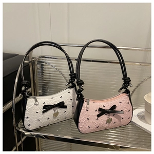 Detail of sweet bow armpit bags with heart charms and subtle pleated texture fabrics