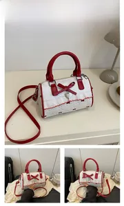 Detail view of the red bow and lace frill decoration on the dotted Boston shoulder bag