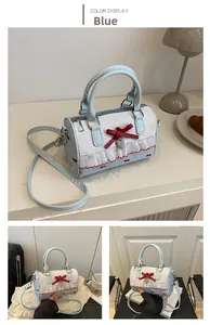 Detail of light blue bow bag with white lace trim and heart pendant in a cozy lifestyle setting