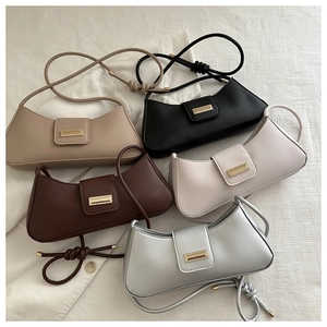 Collection of minimalist baguette bags in five colors with sleek gold metallic buckles