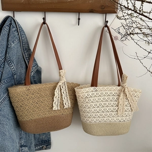 Bohemian large straw tote bags with lace bows and leather straps in a minimalist setting