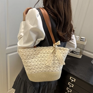 Chic beige lace woven shoulder bag with brown leather strap and large bow detail