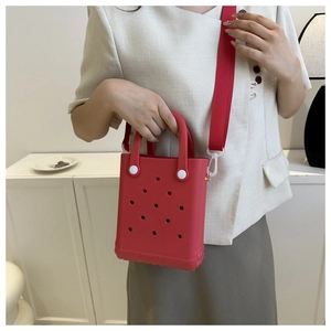 Detail der roten EVA-Tragetasche mit Lochmuster und passendem Nylon-Schultergurt