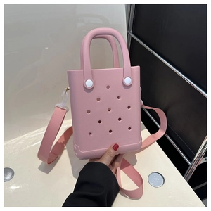 Detail der rosa EVA-Strandtasche mit Lochdesign und verstellbarem Textilschultergurt