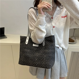 Chic black polka dot tote bag with silver straps and metal plate shown in a mirror selfie
