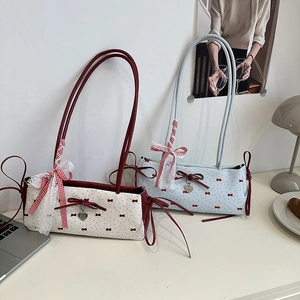 Polka dot baguette shoulder bag with red ribbon bow and heart pendant detail