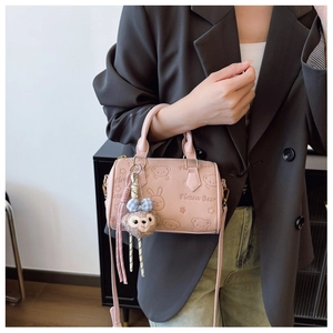 Pink embossed handbag styled with casual blazer and denim jeans for fashion display