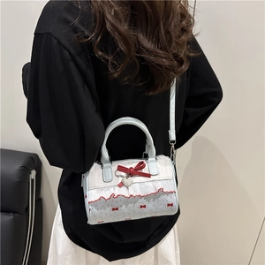 Chic light blue mini cylindrical handbag with red bow prints and white lace trim