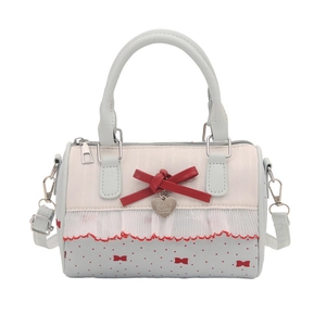 Blue and white Boston shoulder bag with red bow and heart pendant on white background
