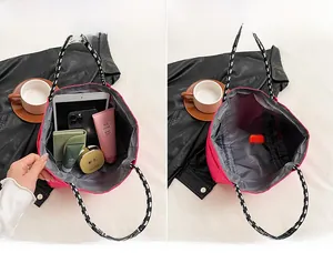 Detail view of pink nylon tote showing spacious interior for daily essentials storage