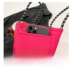 Detail view of pink nylon tote side pocket for large smartphone storage