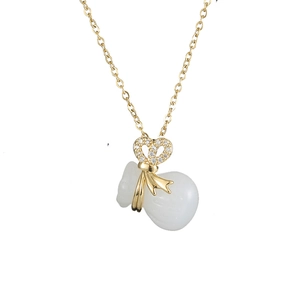 Elegant gold chain necklace with sparkling crystal bow and white jade-like lucky bag pendant